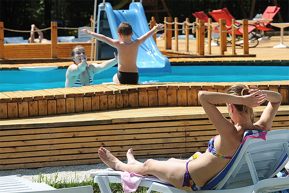 Посетители бассейна в Сокольниках наслаждаются солнечной погодой.