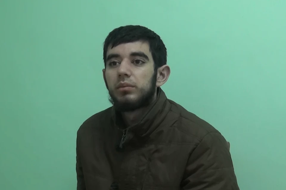 Один из боевиков, рассказывающий о подготовке терактов. Фото: стоп-кадр оперативного видео НАК.