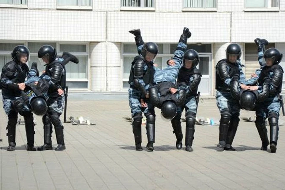 Именно в такой позе задержанных хулиганов удобнее нести в автозаки.