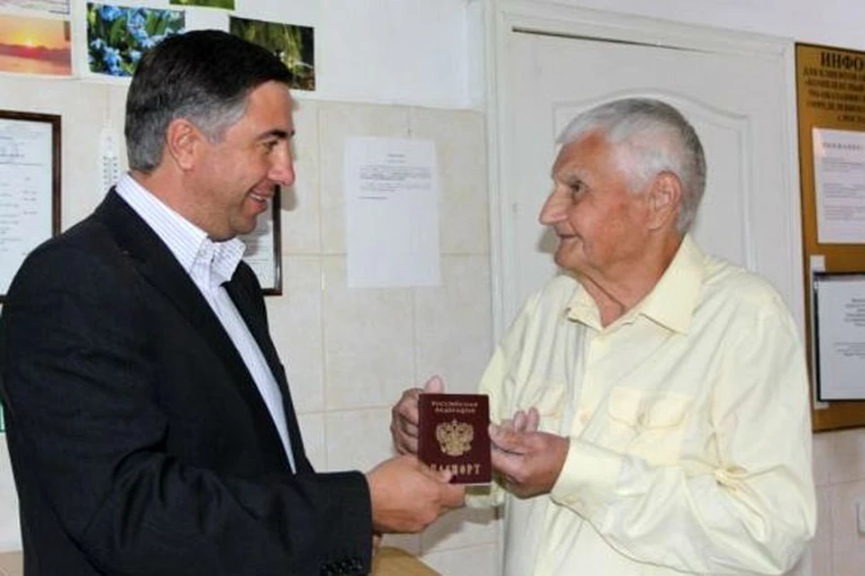 Владимир Бунин (справа) после «воскрешения» получает паспорт.