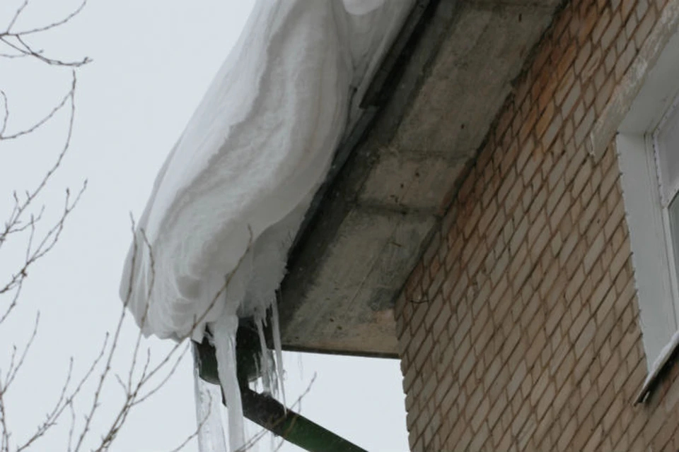 Снег скатился с козырька первого этажа. 
Фото: архив КП